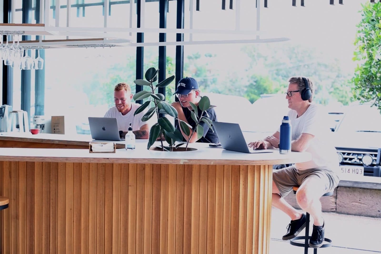 Members working on laptops at the bar in the Hub's shared area